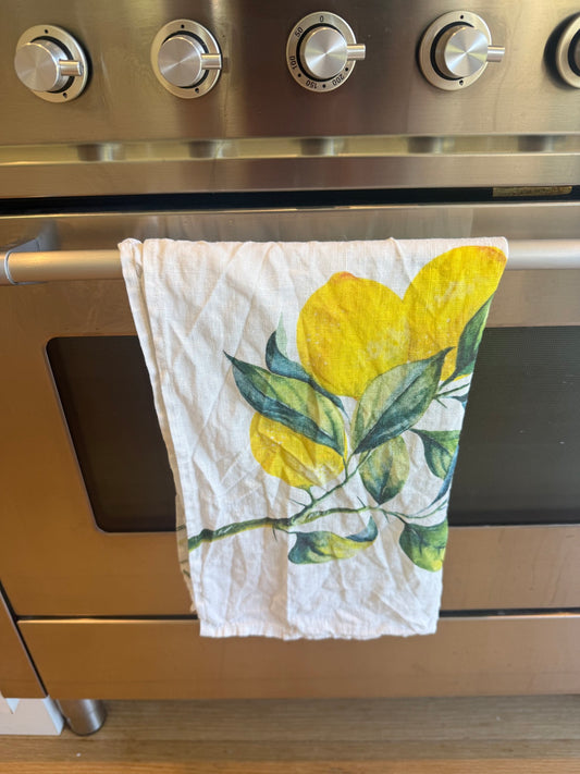 Lemons linen tea towel hanging on our oven door