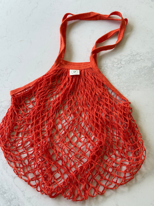 Orange cotton net bag laid flat
