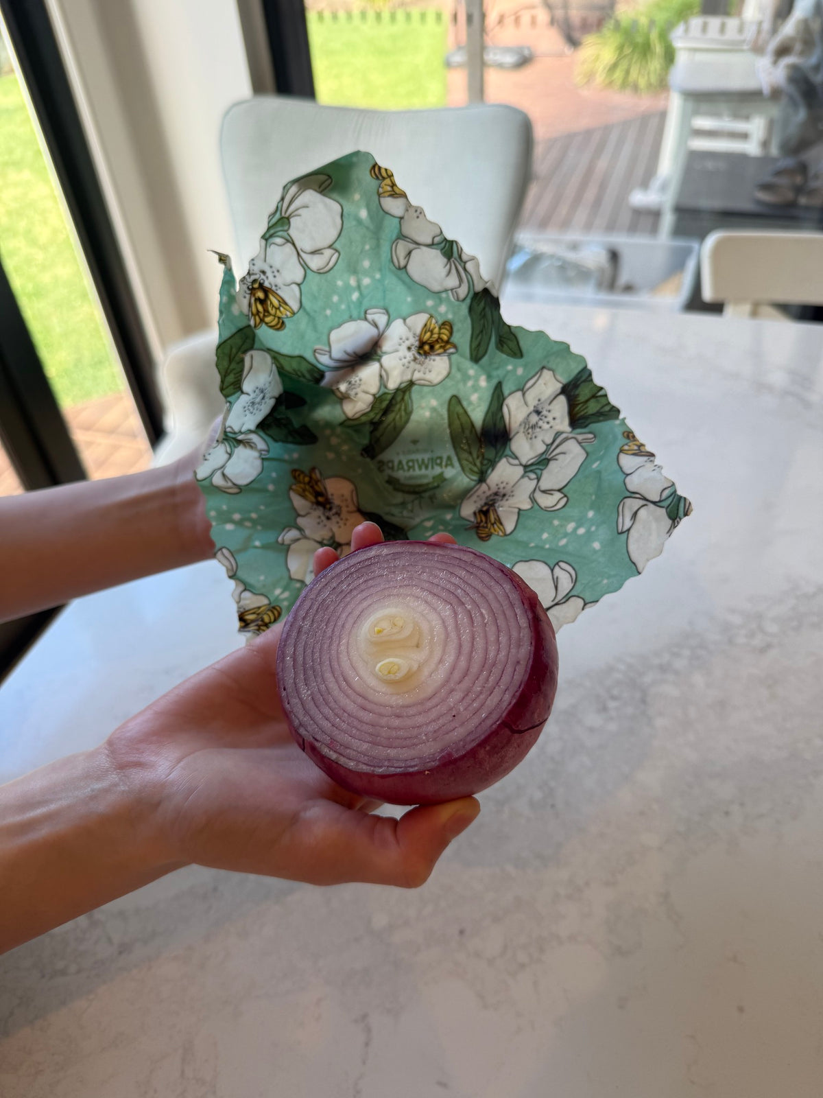 Half a red onion about to be wrapped in a beeswax wrap