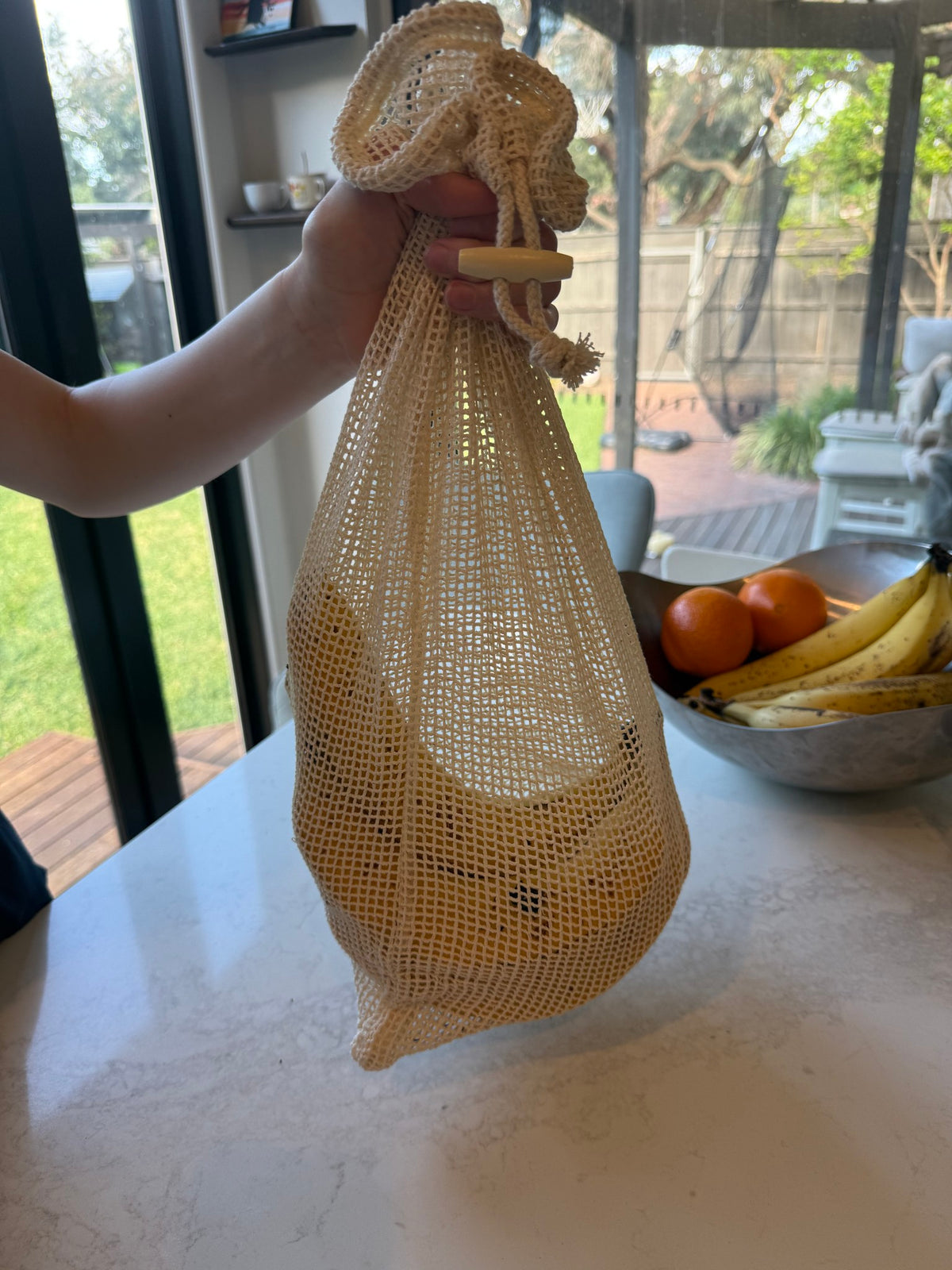 Cotton mesh produce bag filled with fruit