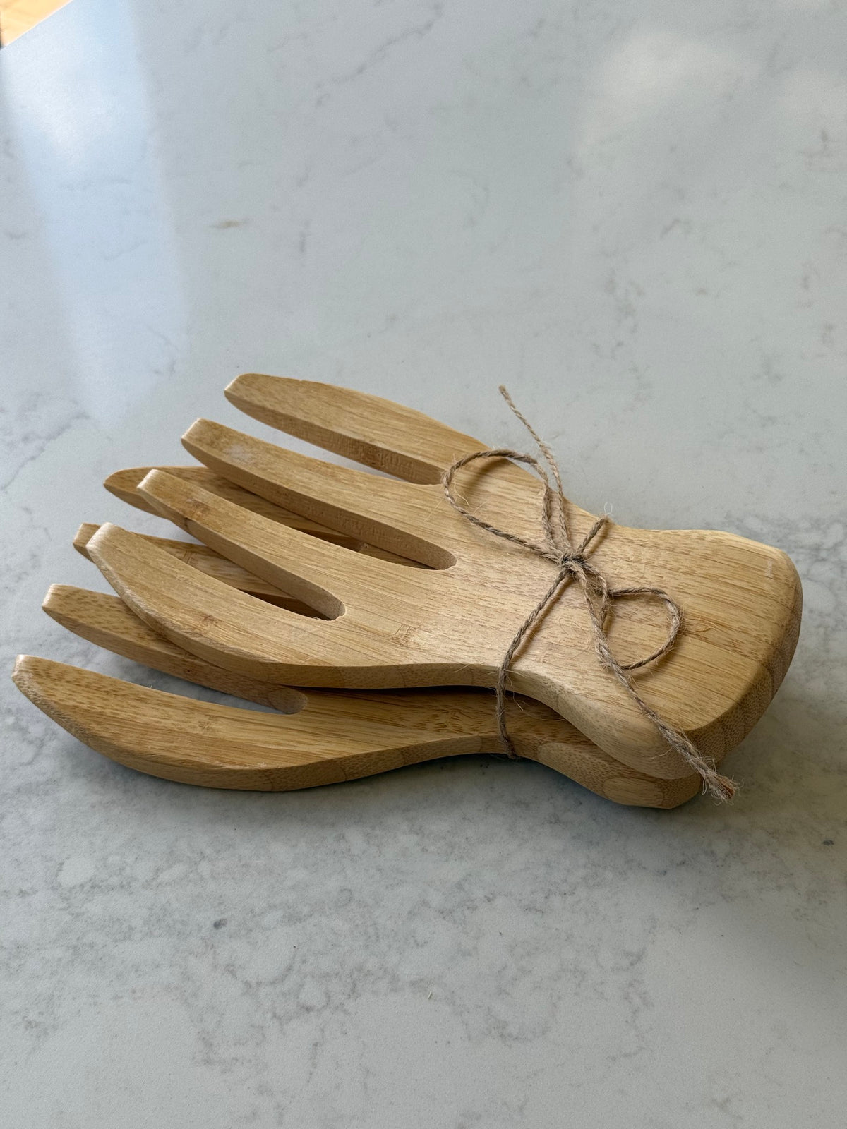 Pair of bamboo salad hands tied with twine, on our kitchen bench in Bayside