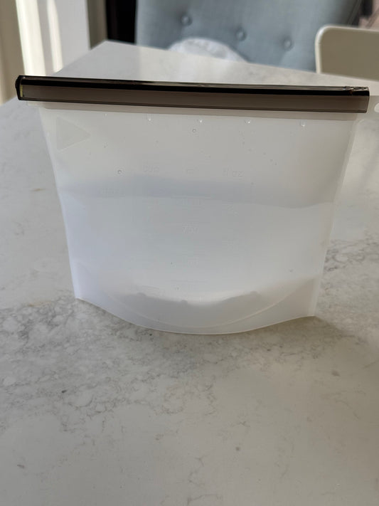 1L silicone food storage bag standing up, filled with water, on our kitchen bench in Bayside